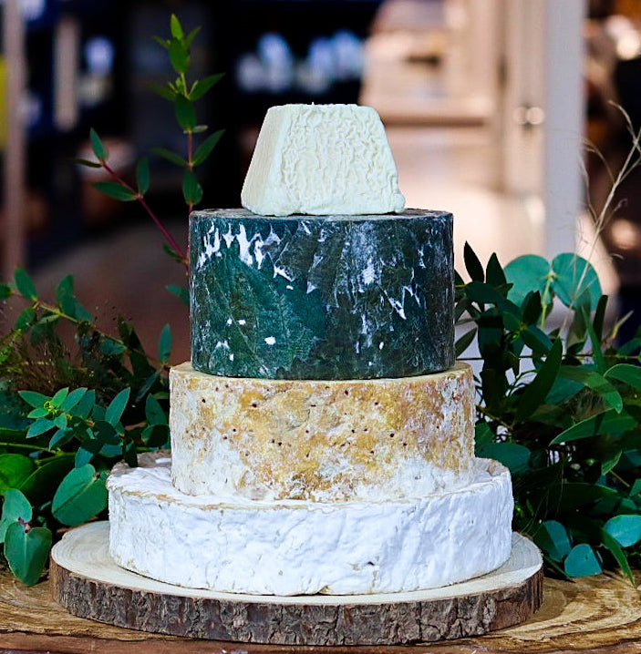 Scholar cheese tower with four tiers of British artisan cheese and floral decoration