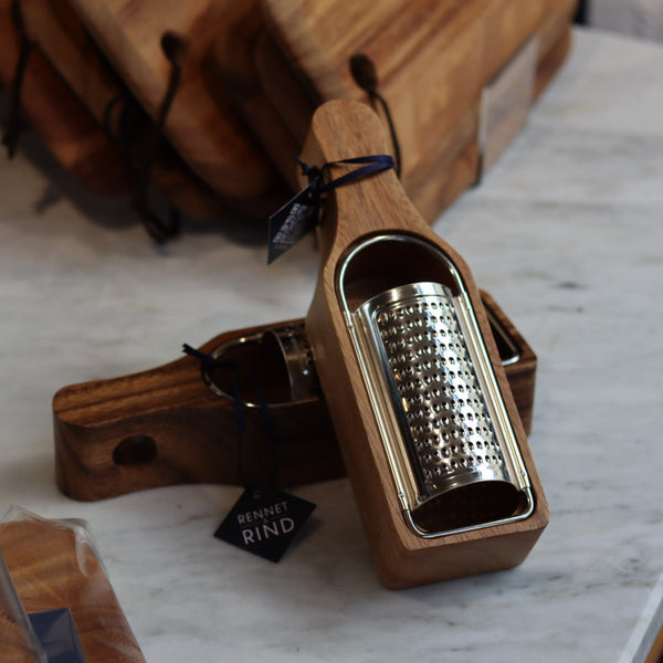 Wooden grater with metal surface on a marble countertop