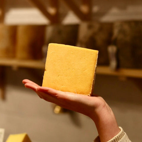 A hand cut piece of Appleby's Red Cheshire, British Artisan Cheese available from Rennet & Rind
