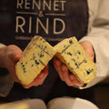 British Artisan Cheesemonger with wedge of Barkham Blue Cheese from Rennet & Rind