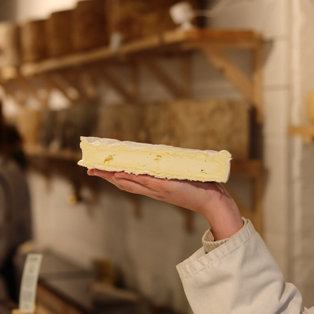 Rennet & Rind Cheesemonger holding British Artisan Cheese, Baron Bigod