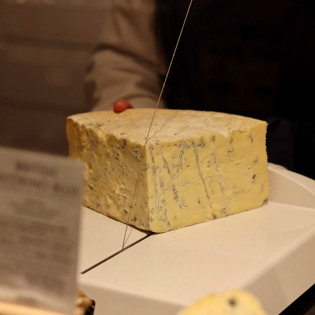 British Artisan Cheesemonger cutting Creamy Blue Cheese, Beauvale at Rennet & Rind