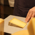 Hand wrapping Ducketts Caerphilly artisan cheese to order at Rennet & Rind.