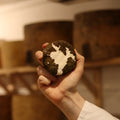 Eve British artisan cheese held by a Rennet & Rind cheesemonger.