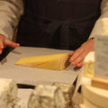 Ogleshield British artisan cheese being wrapped by cheesemonger at Rennet & Rind.