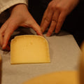 British Artisan Cheese Old Winchester being wrapped by hand by cheesemonger at Rennet & Rind 