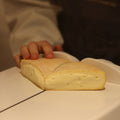 British Artisan Reblochon style cheese Raedwald being cut to order at Rennet & Rind