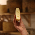 Cheesemonger holding freshly cut piece of British Artisan Cheese Raedwald at Rennet & Rind