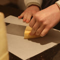 British artisan cheese Raedwald being wrapped for customer at Rennet & Rind