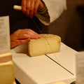 Rennet & Rind Cheesemonger cutting piece of British Artisan Sheep Rustler to order.