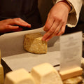 Rennet & Rind Cheesemonger wrapping piece of Sheeps milk artisan cheese, Rustler