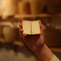 Rennet & Rind Cheesemonger holding freshly cut piece of British artisan goats cheese, Shilling 