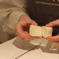 Cheesemonger cutting British Artisan goats cheese, Shilling to order at Rennet & Rind