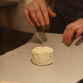 Cheesemonger wrapping British Artisan Goats cheese, Shilling, for customer at Rennet & Rind 