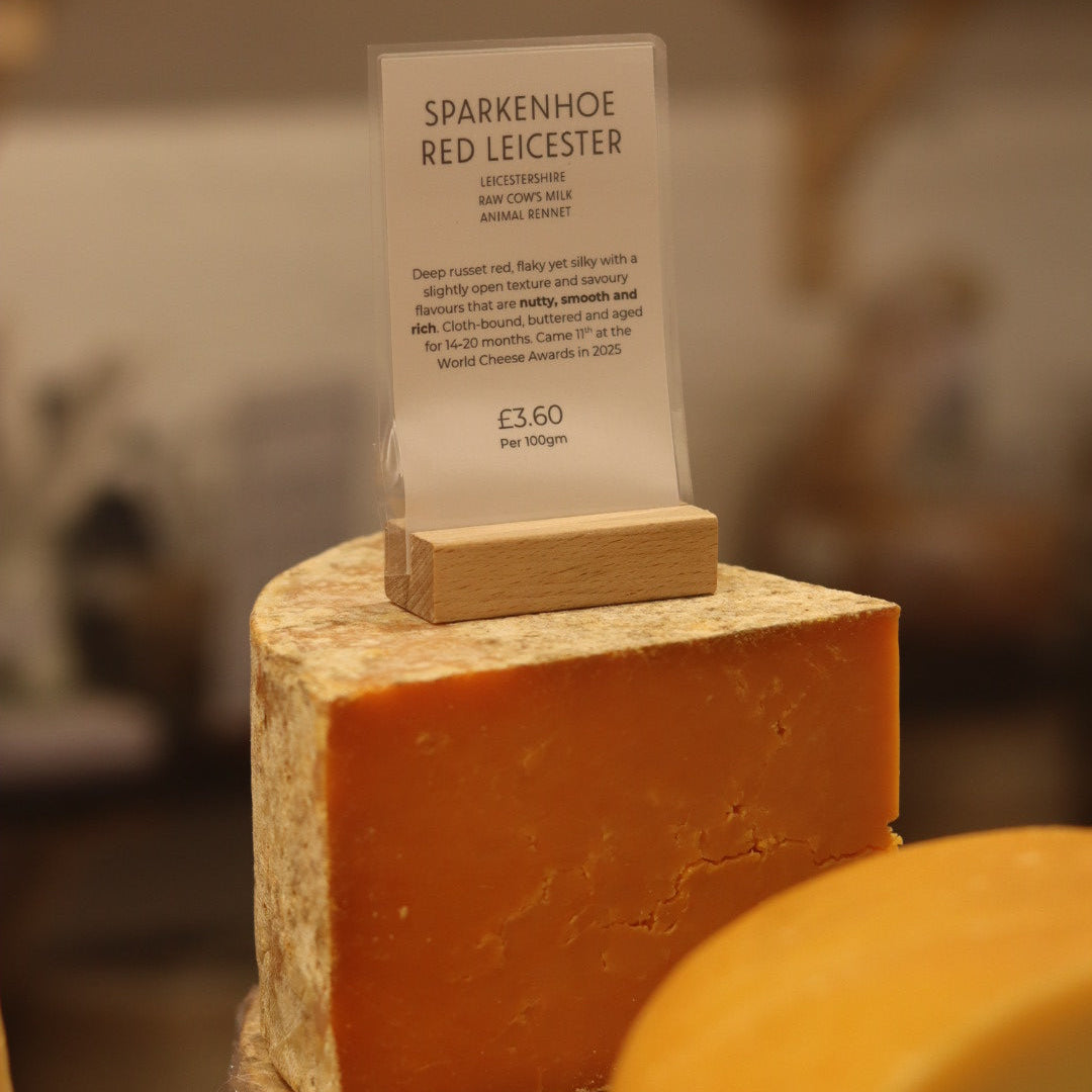 Wedge of British Artisan Cheese, Sparkenhoe Red Leicester on display in Rennet & Rind