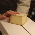 Wedge of Spenwood, British Sheep's milk cheese being cut to order at Rennet & Rind 