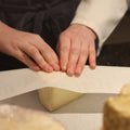 Rennet & Rind cheesemonger wrapping piece of British artisan Spenwood cheese for a customer. 
