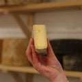 Rennet & Rind Cheesemonger holding piece of British artisan cheese, St Helena