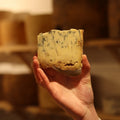 cheesemonger holding piece of British artisan blue cheese, Stichelton at Rennet & Rind