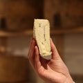 Rennet & Rind cheesemonger holding piece of British Artisan Blue cheese, The Duke