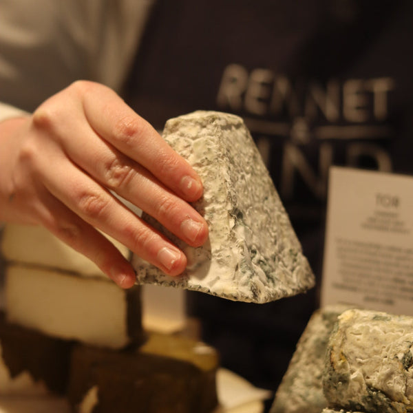 British artisan goats cheese Tor displayed on cheese counter at Rennet & Rind 