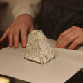 Rennet & Rind cheesemonger wrapping Tor, British artisan goats cheese by hand