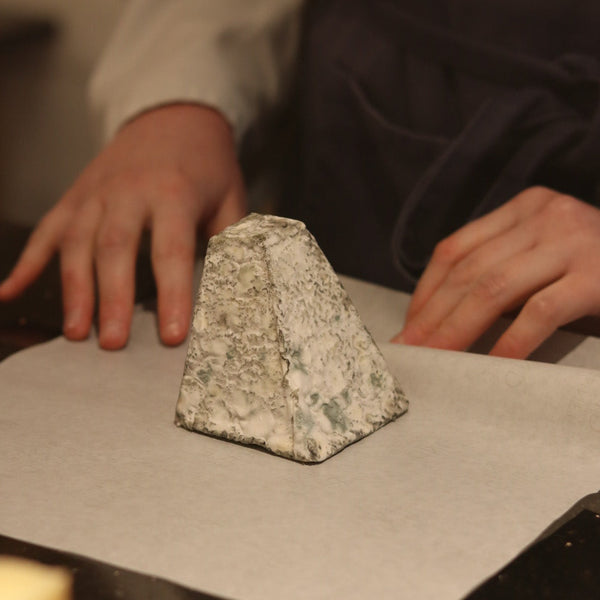 Rennet & Rind cheesemonger wrapping Tor, British artisan goats cheese by hand