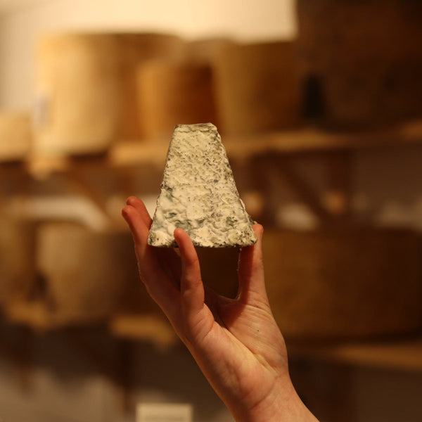 Rennet & Rind Cheesemonger holding Tor, a british artisan goats cheese