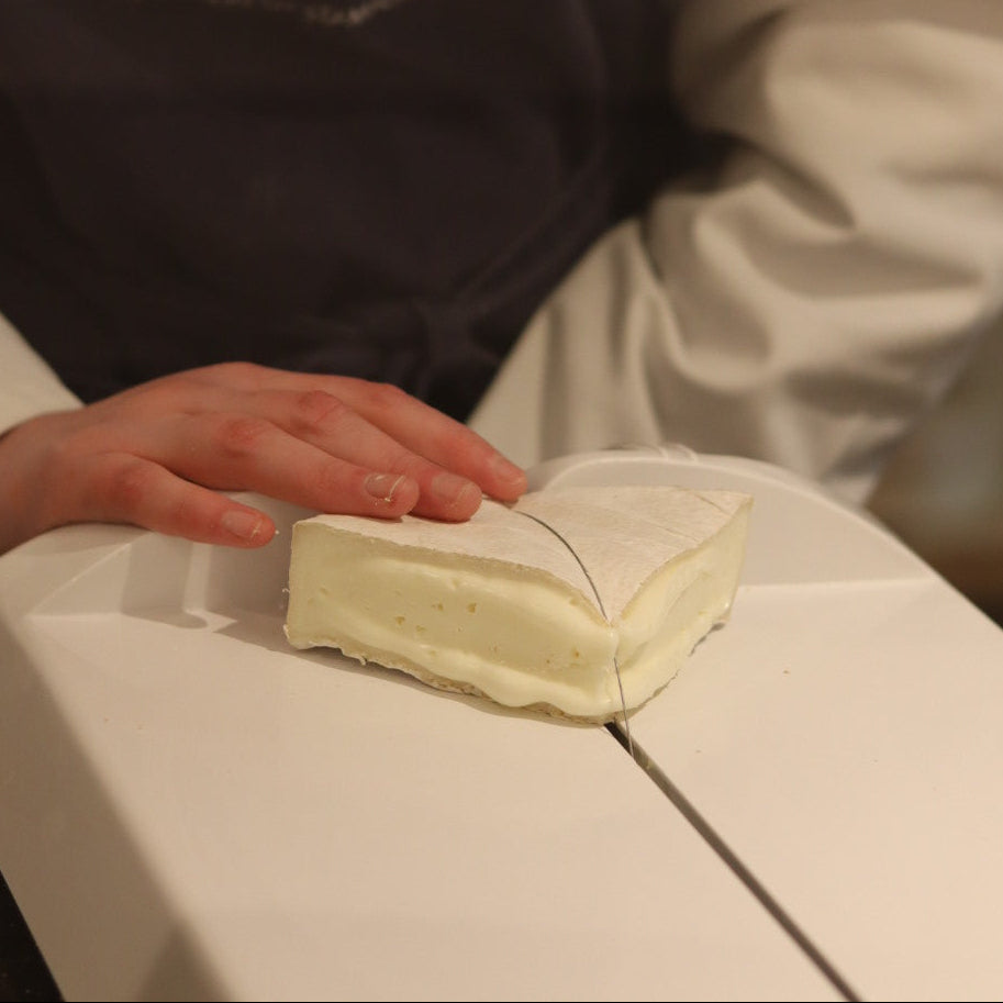 Wigmore goats cheese being cut by Rennet & Rind cheesemonger 